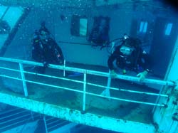 Three scuba divers on the Vandenberg wreck in Key West